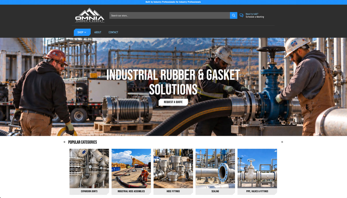 A website homepage screenshot for Omnia, showing an industrial scene with workers handling large rubber hoses and fittings near pipelines, with the headline 'INDUSTRIAL RUBBER & GASKET SOLUTIONS' and category thumbnails below.